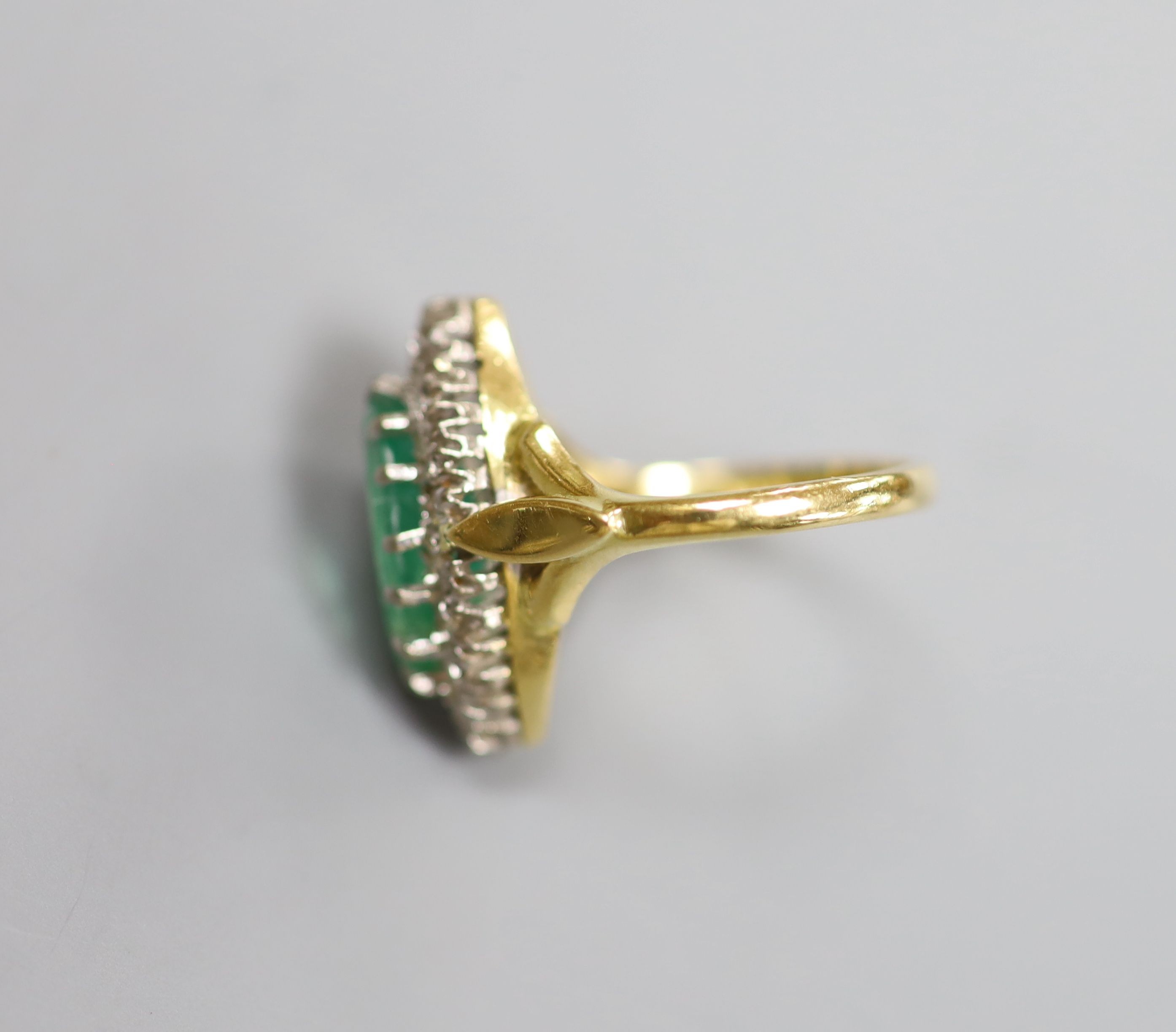 A modern Victorian style 18ct gold, emerald and diamond marquise set dress ring, size L, gross 5.9 grams.